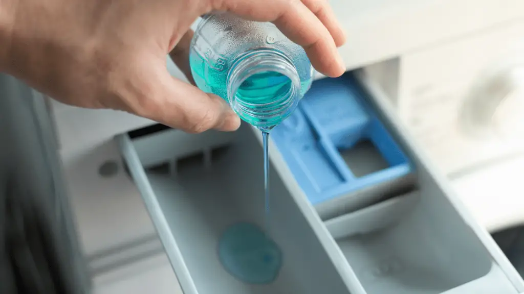 pouring liquid detergent in whirlpool detergent drawer