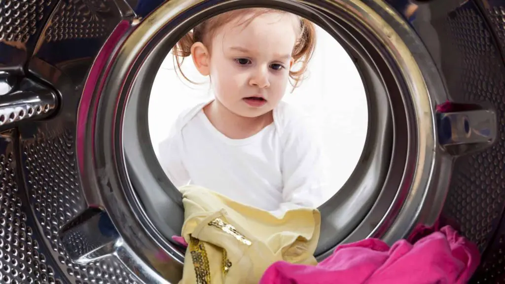girl sitting in front of washer 